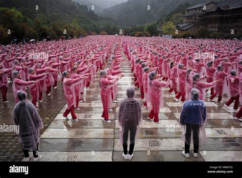 Local Chinese Residents Wearing Raincoats Perform Square Dance In The Rain During An Attempt To