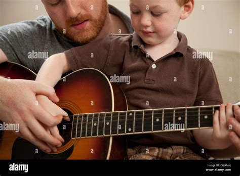 Father Teaching Son To Play Guitar Stock Photo Alamy