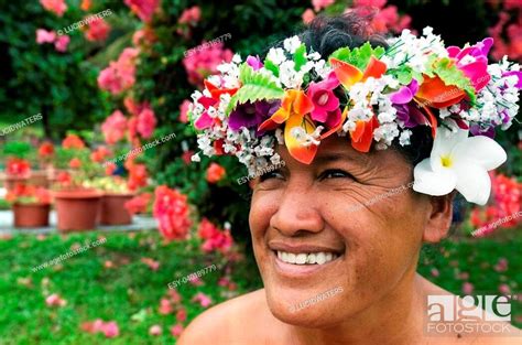 portrait of polynesian pacific island tahitian mature female wearing exotic flowers top bouquet