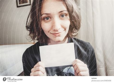 Girl Smiles While Holding A Paper With Her Hands A Royalty Free Stock Photo From Photocase