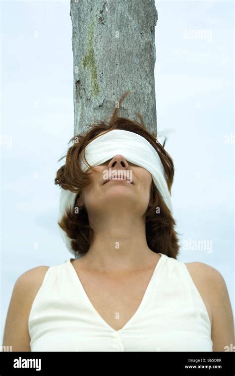 Blindfolded Woman Leaning Against Tree Trunk Stock Photo Royalty Free Image Alamy