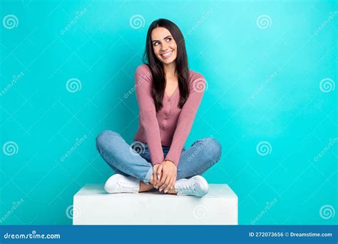 Full Length Cadre Of Dreaming Cute Young Woman Sitting Crossed Legs