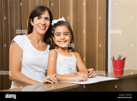 Hispanic Mother And Daughter Portrait With Homework Stock Photo Alamy