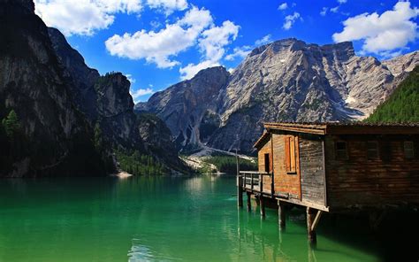 Stilt Cabin On Mountain Lake Wallpaper