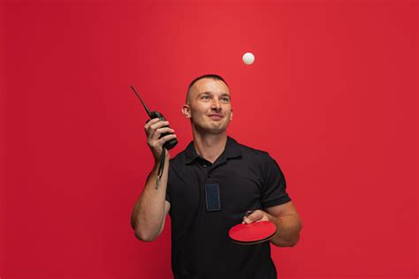 One Young Caucasian Man With Ping Pong Racket And Walkietalkie Playing