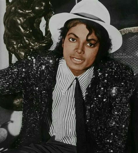 An Old Photo Of Michael Jackson Wearing A White Hat And Black Suit With Striped Shirt