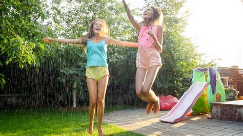 Premium Photo Photo Of Two Happy Laughing Sisters In Wet Clothes