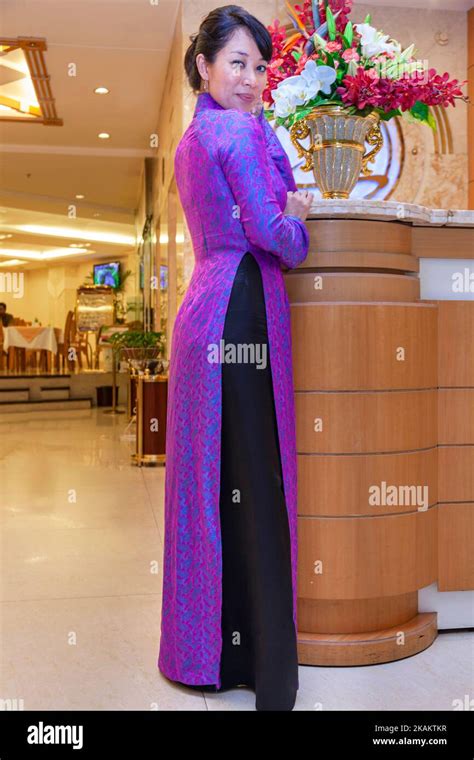 Vietnamese Receptionist Wearing Ao Dai Working In Hotel Ho Chi Minh