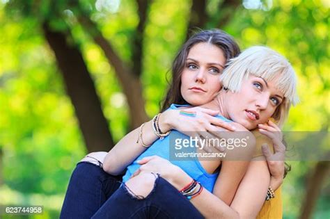 Two Girls Sitting In Park And Embracing Photo Getty Images