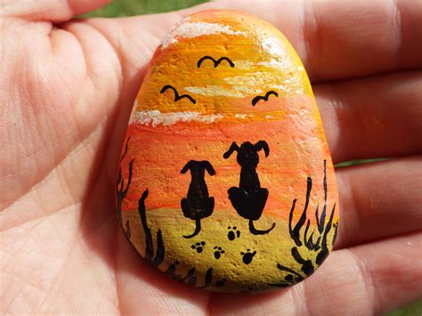 Hand Painted Rock Art Of A Couple Of Dogs On The Beach Birdwatching In