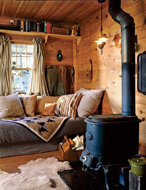 If you've never taken a look inside a tiny home, you might be pleasantly surprised by the chic interiors and the amount of storage space these small abodes can actually offer. Woodsy and cozy tiny house living room. | Cabin living ...