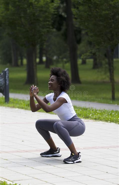 A Black African Or American Woman She Doing Squats On The Street Stock