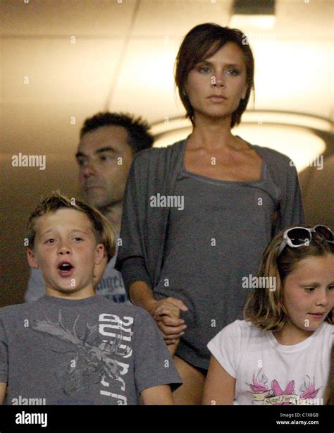 Victoria Beckham Flashes Her Leg As She Stands For The USA National Anthem Prior To Her Husbands