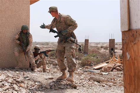 U S Army Cpl Keegan A Merlino Right Guides Iraqi Army Soldiers To Their Next Bounding