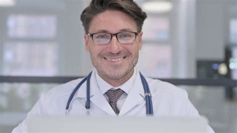 Close Up Of Doctor With Laptop Smiling At Camera Stock Image Image Of