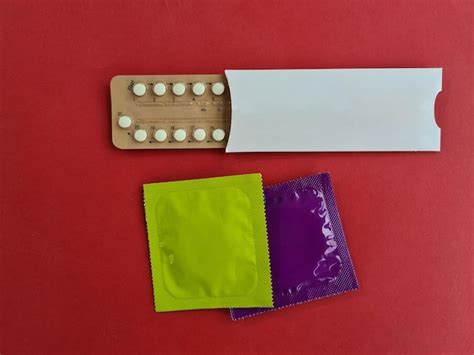 Premium Photo Condoms And Birth Control Pills On Red Background Safe Sex