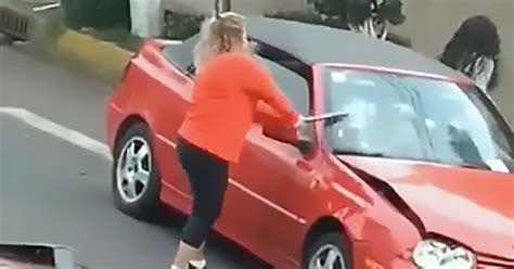 Woman Smashes Car With Metal Pole Before Driving Into It In Road Rage