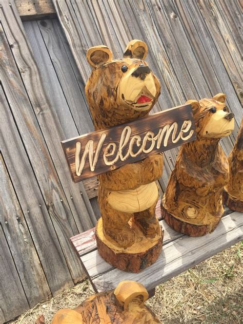 Chainsaw Carving Of Bear Holding Routed Sign By Runtske Art Llc