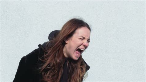 Head Shot Of A Young Woman Screaming In Angst Outdoors Side View