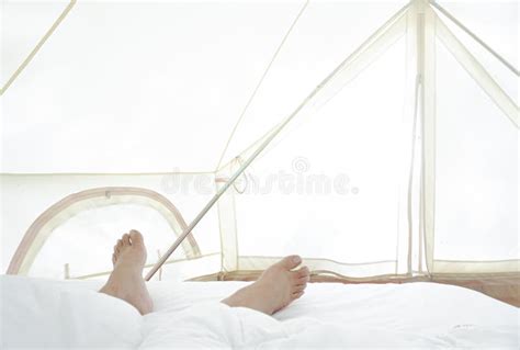 Close Up Of Barefootfeet And Stretch Lazily On The Bed After Waking Up