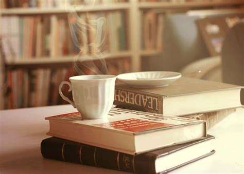 Download A Cup Of Coffee On A Stack Of Books