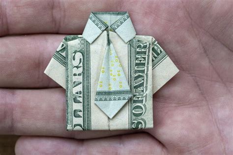 Origami Shirt Made Of Dollar Banknote On Hand Background Closeup