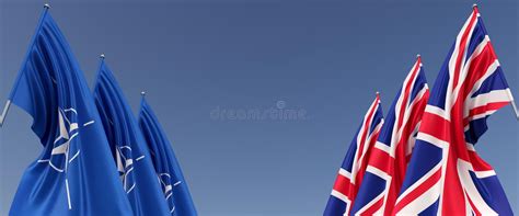 Three Flags Of United Kingdom And Nato On Flagpoles On Sides Flags On