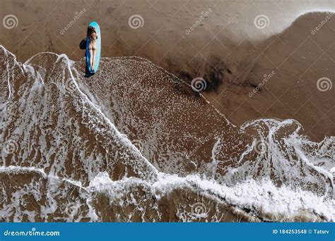Aerial Drone View Of A Woman In Bikini Is Sunbathing On A Surfboard On