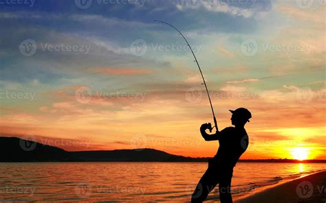 Young Man Fishing At Sunset 12704802 Stock Photo At Vecteezy