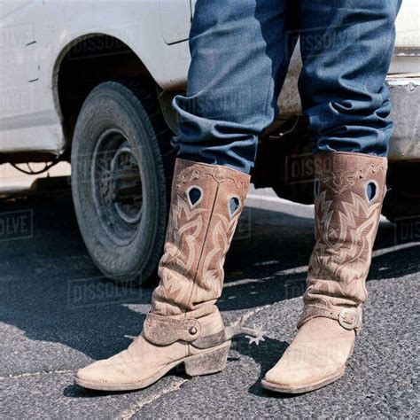 Close Up Of Man Wearing Cowboy Boots With Spurs Stock Photo Dissolve