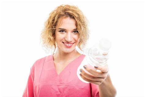 Selective Focus Of Nurse Wearing Pink Scrub Holding Bottle Of Water