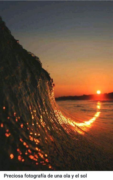 The Sun Is Setting Behind A Wave In The Ocean