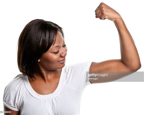 Young Woman Flexes Bicep Muscle High Res Stock Photo Getty Images