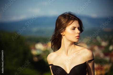 Girl Posing With Naked Shoulders On Natural Landscape Stock Photo And
