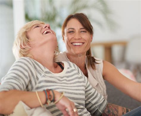 Love And Laughter Portrait Of A Lesbian Couple Relaxing At Home Stock Photo Image Of Inside
