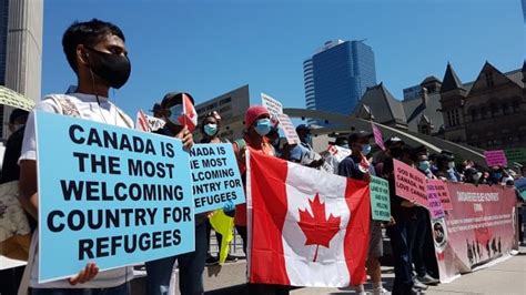 Dozens Gather Downtown To Demand Permanent Status For Refugees Amid
