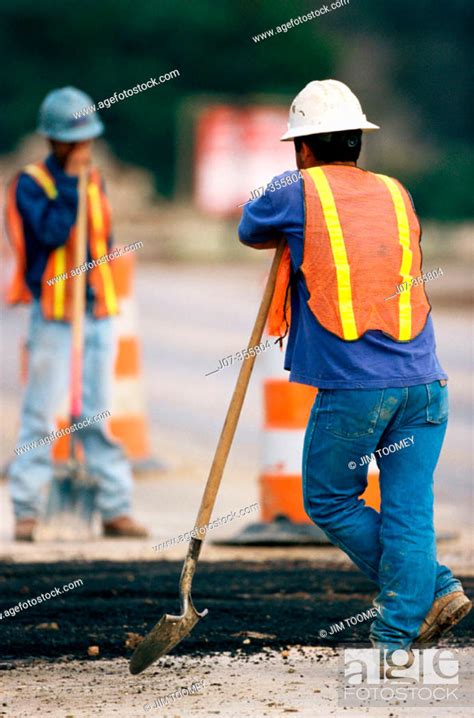 Construction Workers Leaning On Shovels Texas Usa Stock Photo