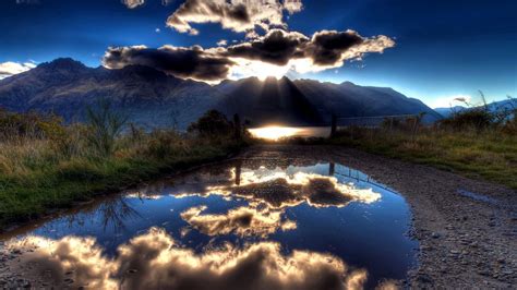 Download Wallpaper 1600x900 Sun Clouds Lake Reflection Light