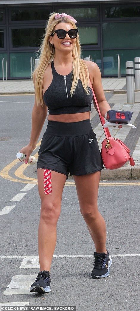 christine mcguinness grapples her ample assets in an ab flashing sports bra and munches on a