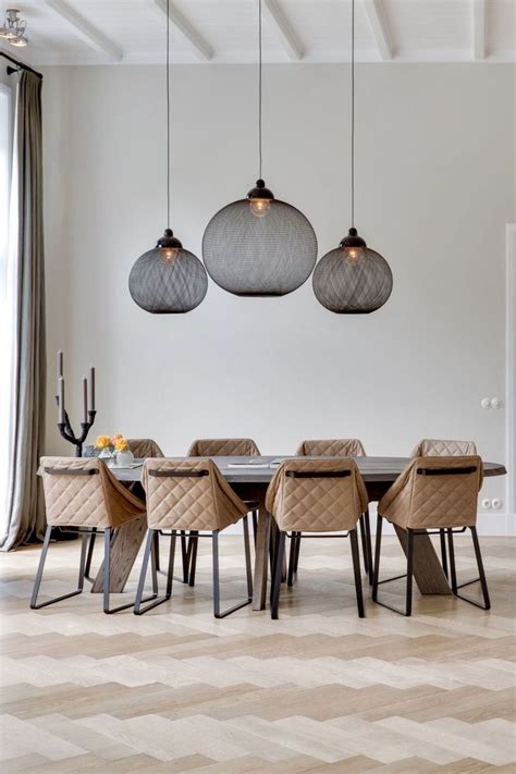 It is accompanied by an elegant beige seat and a baby grand piano against the white walls accented with a dining room with a long rectangular dining table set lighted by a glamorous chandelier. Dramatic pendant lights - great with a full height ceiling ...