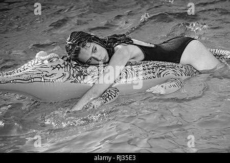 Girl On Inflatable Mattress Crocodile In The Pool Stock Photo