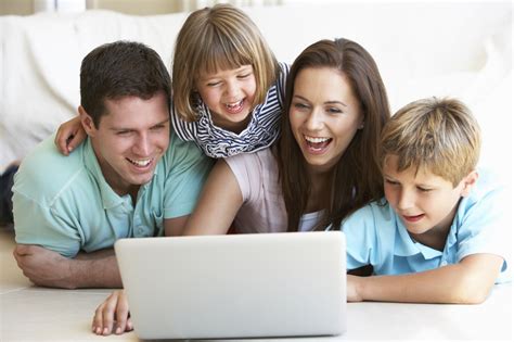 Young Parents With Children On Laptop Computer North Plains