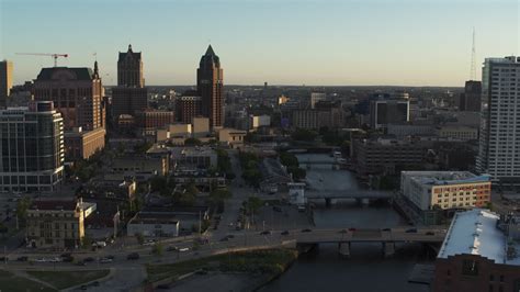 5 7k stock footage aerial video of city buildings and an office tower by the milwaukee river at