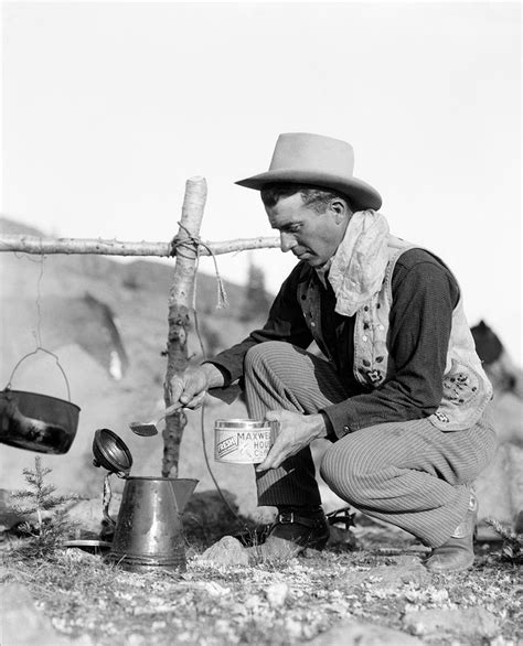 Cowboy Kneeling By Campfire Pouring Photograph By H Armstrong Roberts