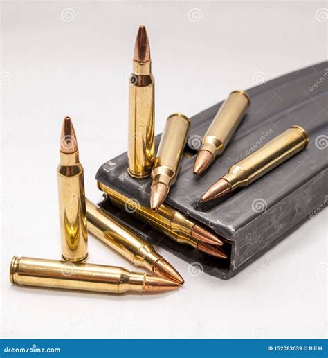 223 Caliber Bullets Along With A Loaded 223 Caliber Rifle Magazine