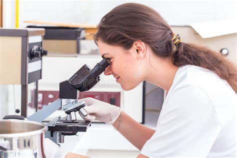 Female Student Looking Into The Microscope Stock Photo Image Of