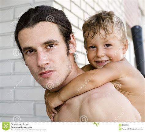 Portrait Of Happy Father With Son Hugging Outside Stock