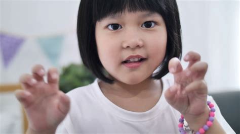 Slow Motion 4k Happy Little Asian Girl Who Pretend To Be Monster Making A Scary Face Stock Video