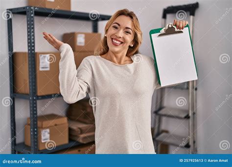 Hispanic Woman Working At Small Business Ecommerce Holding Clipboard With Blank Space