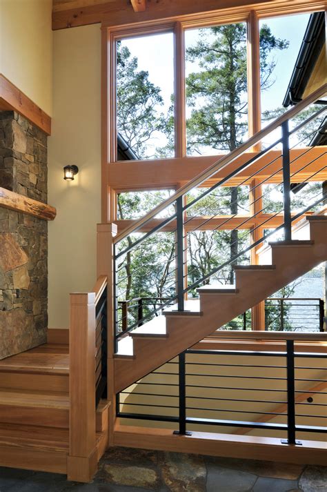 Hints of black on the moroccan rug and a buffalo check pouf tie in with the stair railing's color scheme. Modern Stair Railing Staircase with Bench Glass Shade